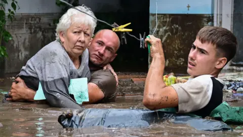 afp two men rescuing a woman