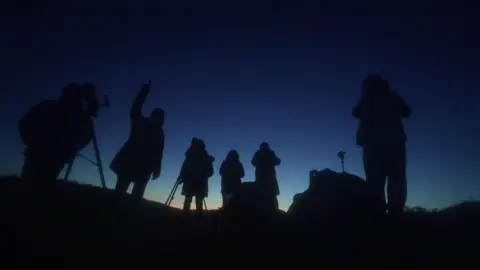 BBC/Tony Jolliffe Astronomers looking at sky in the Dark Skies Reserve of Bannau Brycheiniog in south Wales