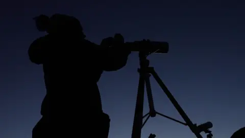 BBC/Tony Jolliffe Jenifer Millard looking through a telescope 